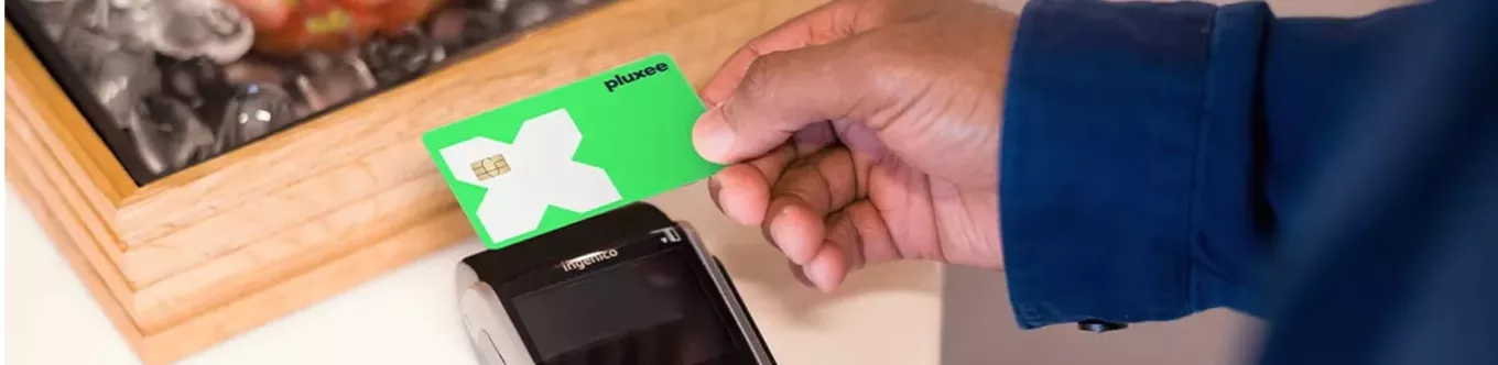tapping green pluxee card on payment machine 