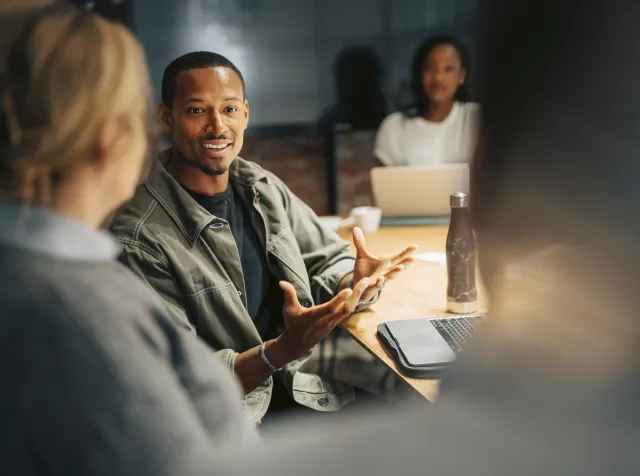 Man speaking with his colleagues