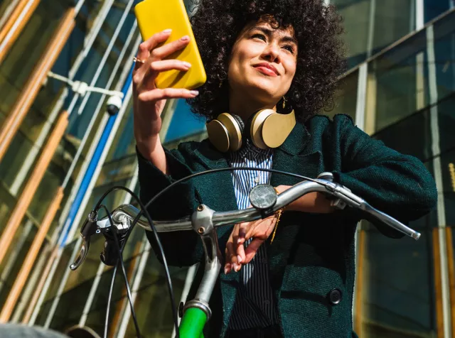 Girl biking and using her phone