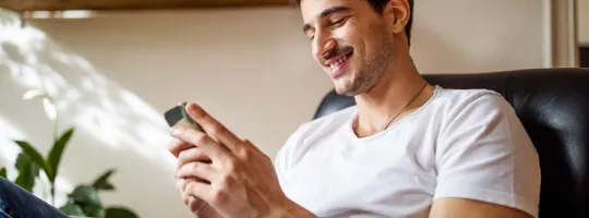 Man on his phone smiling